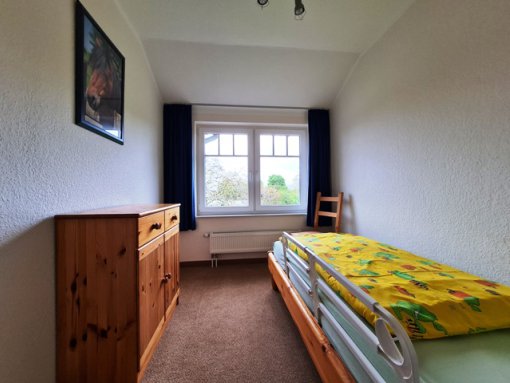 Kinderzimmer mit einem Bett - Ferienhaus Kornblume